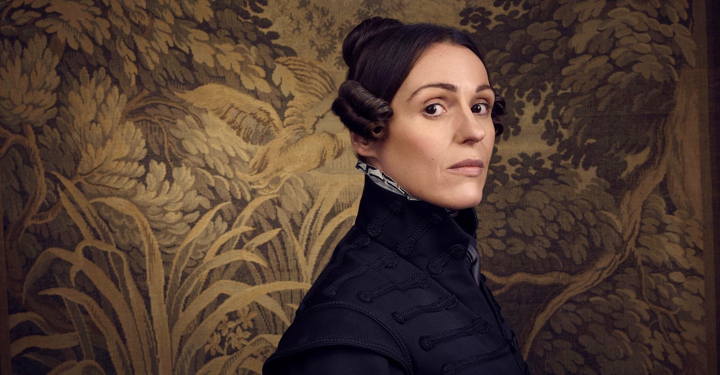 Lead performer in Gentleman Jack wearing dark clothes and standing in front of an ornate background, she has been nominated for a BAFTA for her LGBT+ role